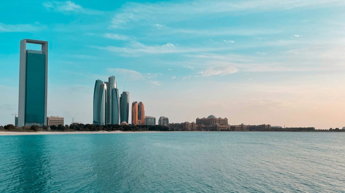 The Abu Dhabi city skyline seen across the water in daylight