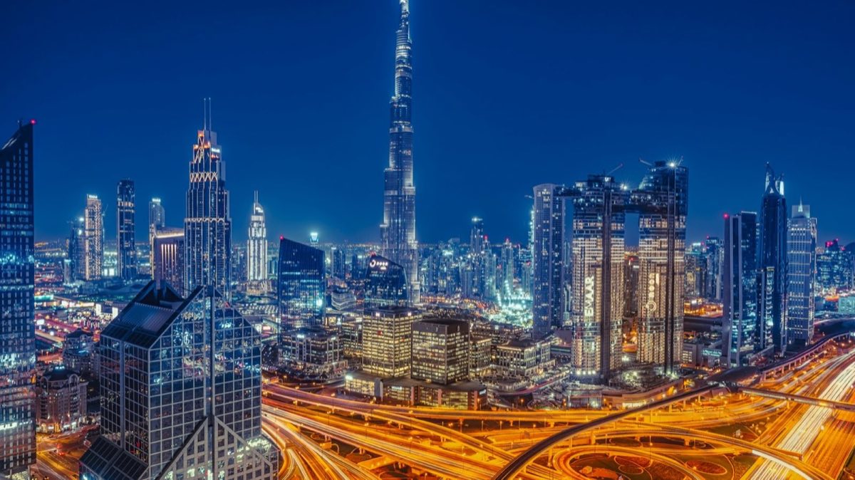 The Burj Khalifa rising above the illuminated skyline of Downtown Dubai at night