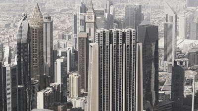 Modern high-rise towers of a financial district against a hazy sky