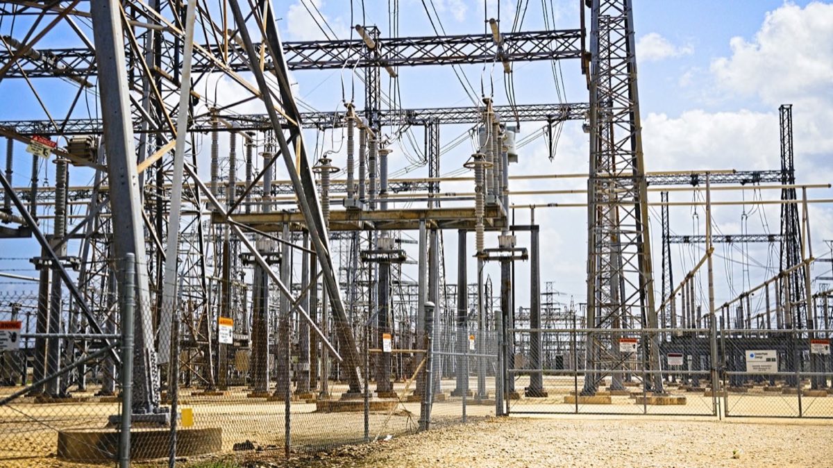 An electrical substation with transmission pylons and overhead lines