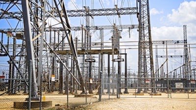 An electrical substation with transmission pylons and overhead lines